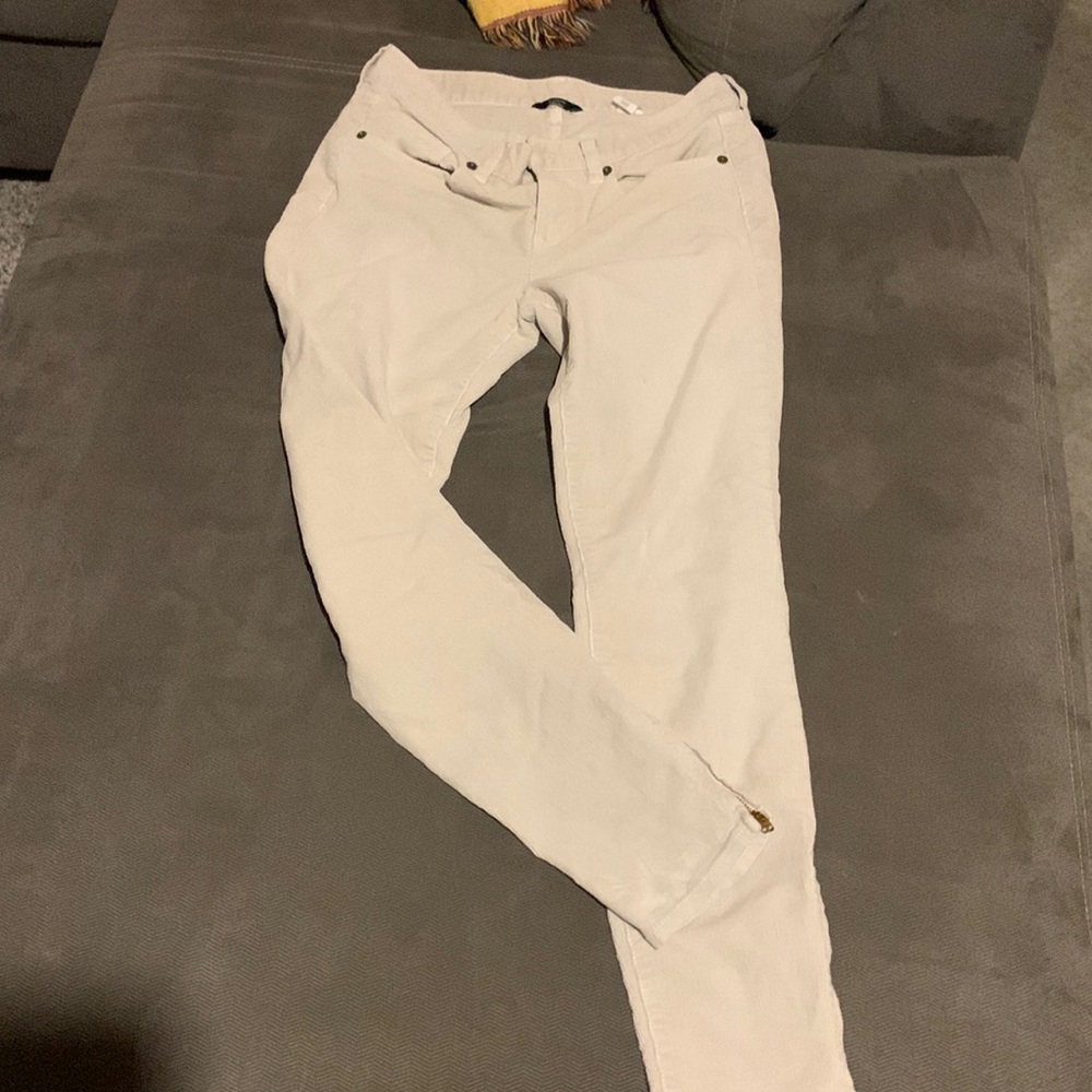 White khakis with zippers on ankles.